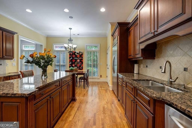 3127 Lenox Rd NE Unit 1, Atlanta, GA 30324 - kitchen with a sink, decorative light fixtures, a chandelier, decorative backsplash, and light wood-style floors