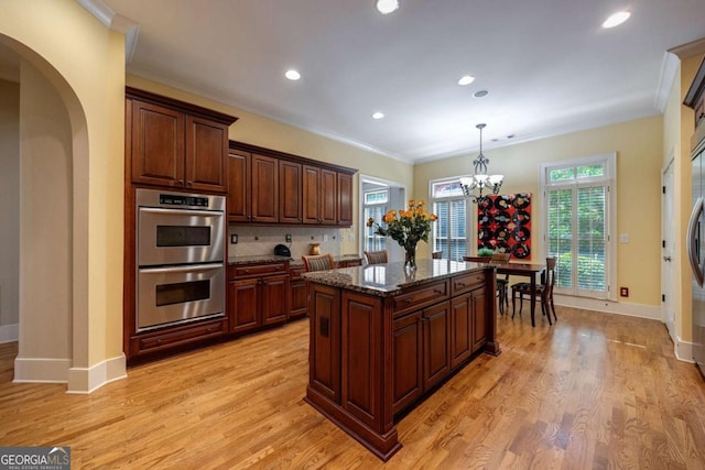 3127 Lenox Rd NE Unit 1, Atlanta, GA 30324 - kitchen with ornamental molding, baseboards, light wood-type flooring, and double oven