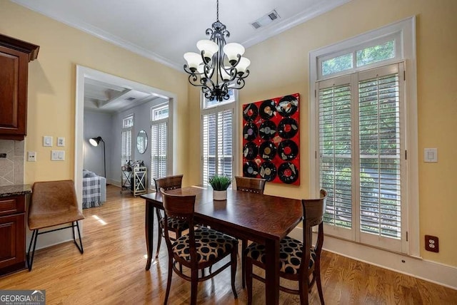 3127 Lenox Rd NE Unit 1, Atlanta, GA 30324 - dining room with light wood finished floors, a chandelier, and crown molding