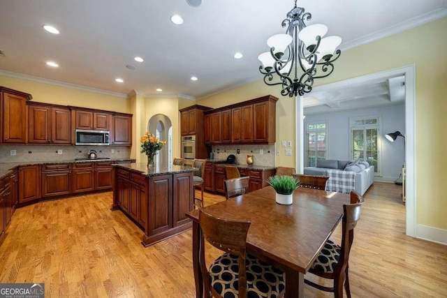 3127 Lenox Rd NE Unit 1, Atlanta, GA 30324 - dining room with light wood finished floors, ornamental molding, a notable chandelier, and recessed lighting