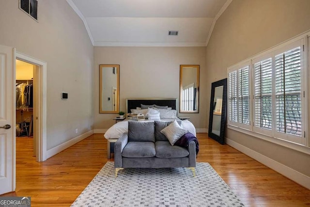 3127 Lenox Rd NE Unit 1, Atlanta, GA 30324 - bedroom featuring ornamental molding, light wood-style floors, visible vents, and vaulted ceiling