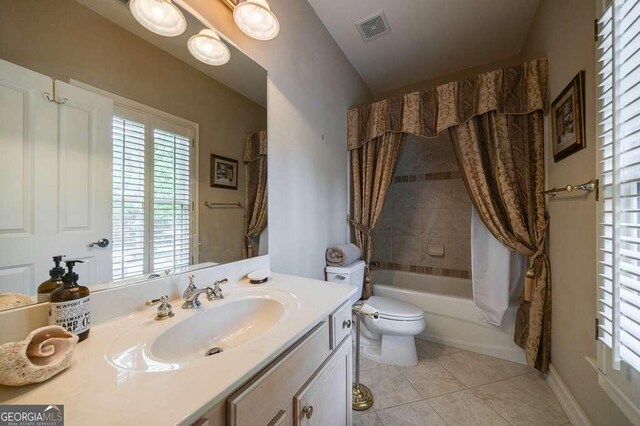 3127 Lenox Rd NE Unit 1, Atlanta, GA 30324 - bathroom featuring toilet, shower / bath combo with shower curtain, vanity, visible vents, and tile patterned floors