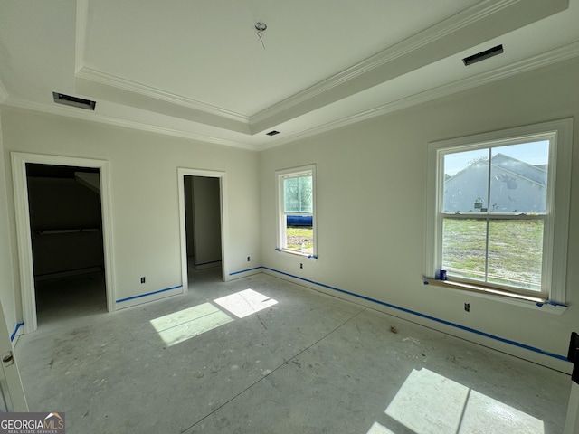 47 Ennis Rd, Pembroke, GA 31321 - unfurnished bedroom featuring visible vents, crown molding, a spacious closet, a raised ceiling, and baseboards