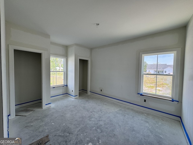 47 Ennis Rd, Pembroke, GA 31321 - unfurnished bedroom featuring multiple windows, a baseboard radiator, and concrete flooring