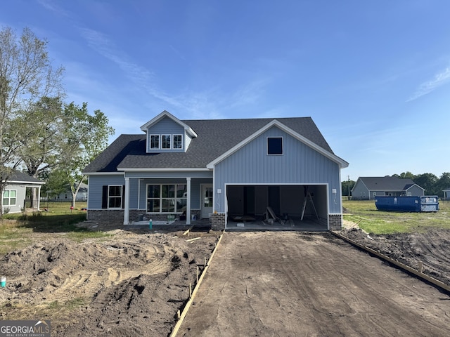 47 Ennis Rd, Pembroke, GA 31321 - view of front of home featuring driveway, brick siding, an attached garage, a shingled roof, and a porch