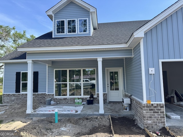 47 Ennis Rd, Pembroke, GA 31321 - rear view of house featuring board and batten siding, a porch, and roof with shingles
