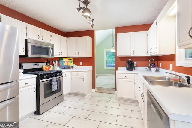 1605 Barrier Rd, Marietta, GA 30066 - kitchen featuring appliances with stainless steel finishes, a sink, light countertops, and white cabinets