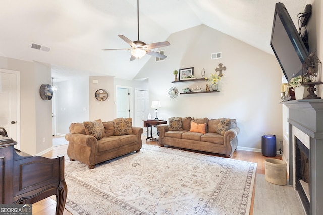 1605 Barrier Rd, Marietta, GA 30066 - living area featuring lofted ceiling, light wood-style floors, ceiling fan, a fireplace with flush hearth, and baseboards