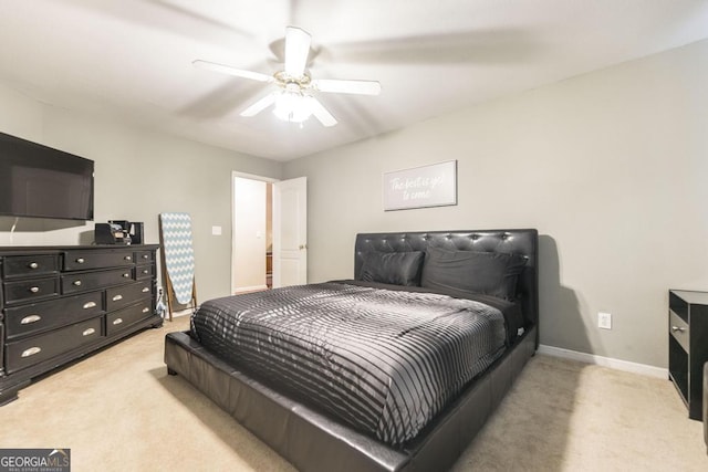bedroom featuring ceiling fan, light carpet, and baseboards