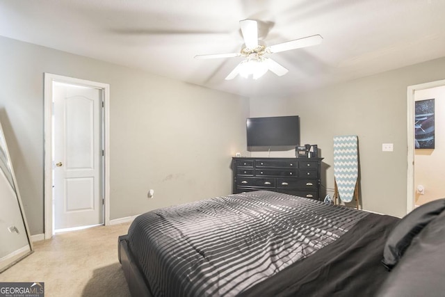 bedroom featuring light carpet, baseboards, and ceiling fan