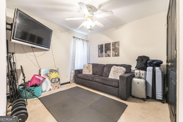 living area featuring light colored carpet and ceiling fan