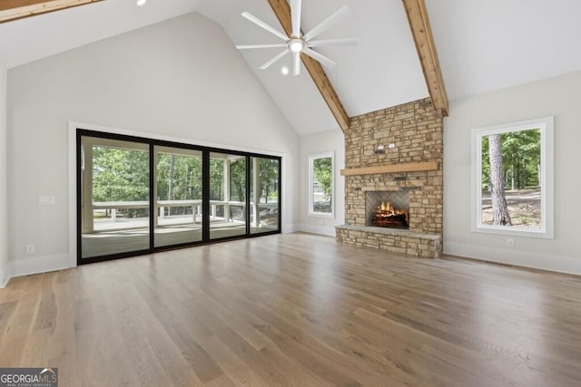 1301 Grayson Pointe Dr, Buckhead, GA 30625 - unfurnished living room with high vaulted ceiling, a ceiling fan, a fireplace, baseboards, and wood finished floors