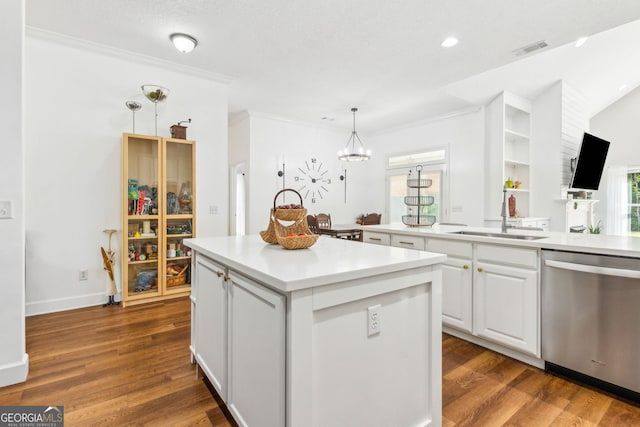kitchen featuring dishwasher, a sink, a center island, white cabinetry, and pendant lighting