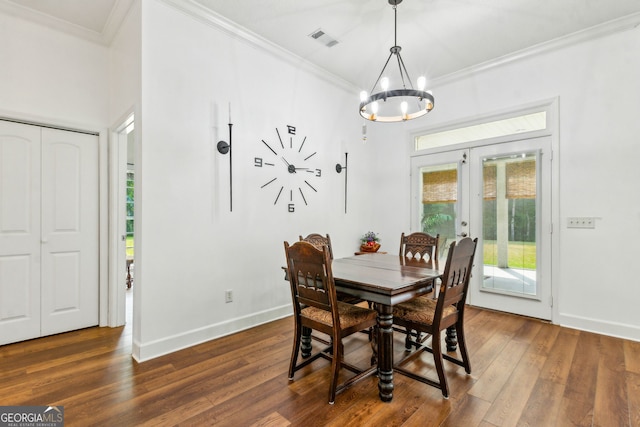 dining room featuring crown molding, french doors, a chandelier, baseboards, and wood finished floors