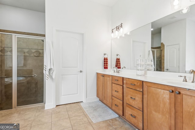 bathroom featuring double vanity, a stall shower, and tile patterned floors