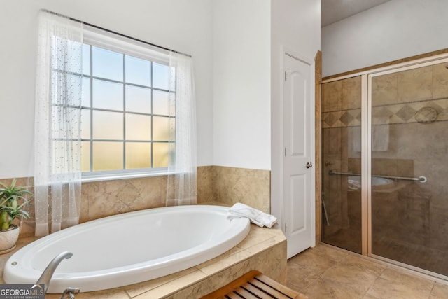 full bathroom featuring a stall shower, a bath, and healthy amount of natural light