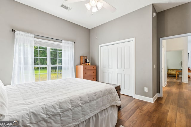 bedroom featuring wood finished floors, baseboards, a closet, and ceiling fan