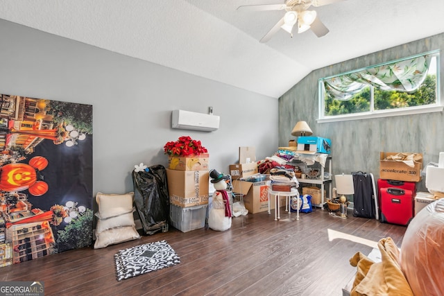 rec room with a wall mounted AC, ceiling fan, wood finished floors, and lofted ceiling