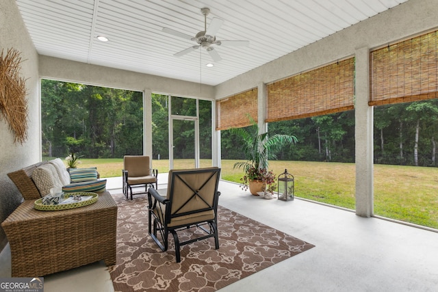 sunroom featuring ceiling fan, healthy amount of natural light, and an outdoor hangout area