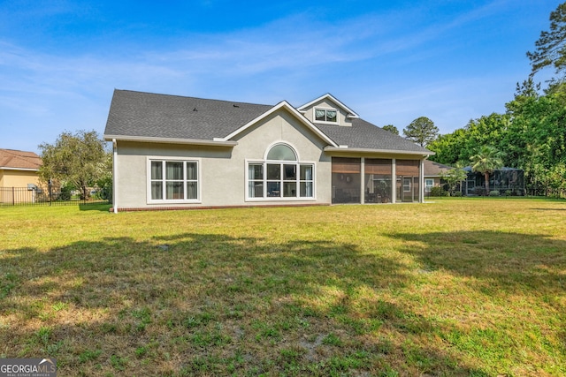 back of house featuring stucco siding, a sunroom, and a shingled roof