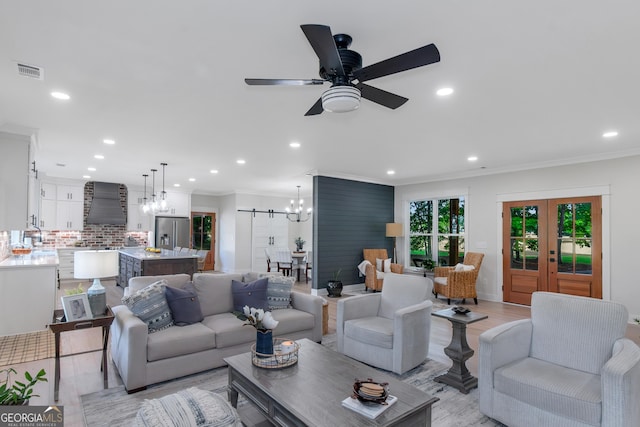 living room with recessed lighting, ornamental molding, light wood finished floors, and visible vents