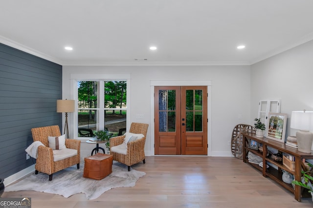 living area featuring crown molding, french doors, recessed lighting, and wood finished floors