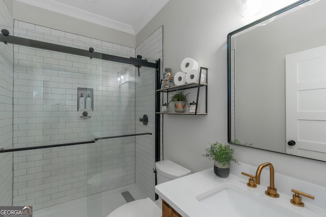 bathroom with toilet, ornamental molding, vanity, and a stall shower