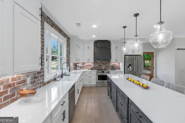 kitchen with stainless steel appliances, custom exhaust hood, backsplash, light countertops, and white cabinets