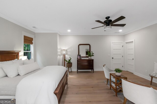 bedroom with light wood-style flooring, baseboards, ornamental molding, and recessed lighting