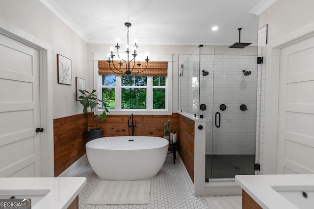 bathroom featuring vanity, a stall shower, crown molding, an inviting chandelier, and a soaking tub