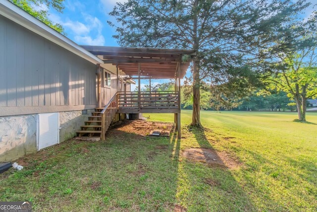 view of yard with a wooden deck and stairs