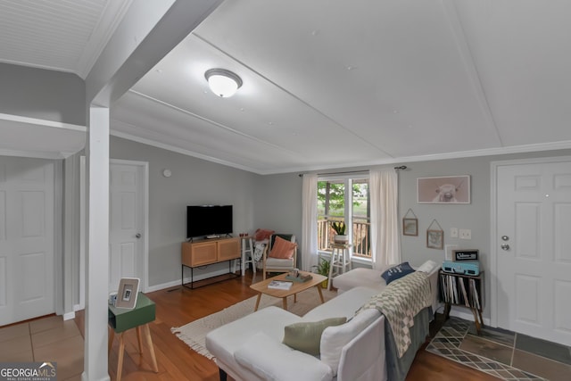 living room featuring crown molding, wood finished floors, and lofted ceiling