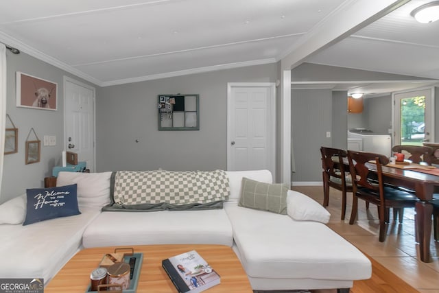 living room featuring washing machine and clothes dryer, ornamental molding, and wood finished floors