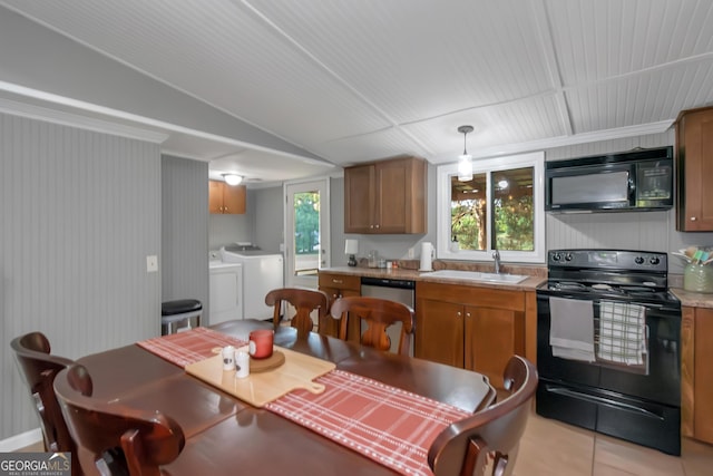 dining room with light tile patterned flooring and independent washer and dryer