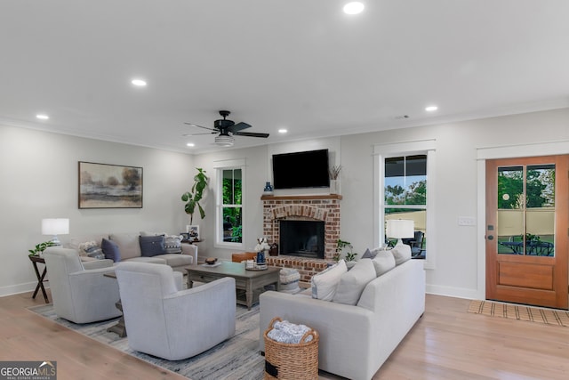 living area with light wood-style floors, plenty of natural light, and recessed lighting