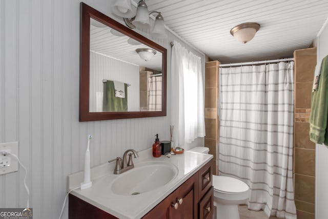 bathroom with wallpapered walls, toilet, vanity, and a shower with curtain
