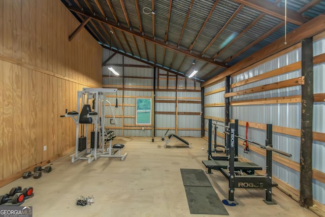 exercise room with metal wall and high vaulted ceiling