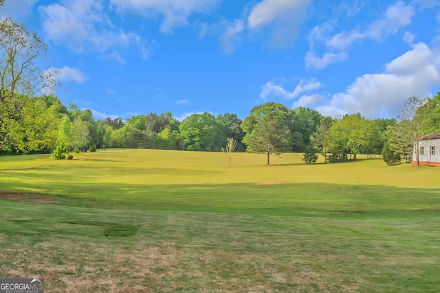 view of community with a yard and golf course view
