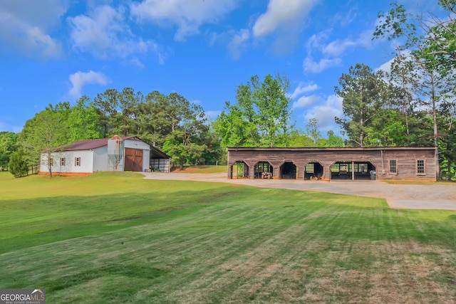 exterior space with view of golf course, an outdoor structure, a carport, and an outbuilding