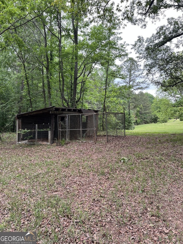 view of yard with a view of trees