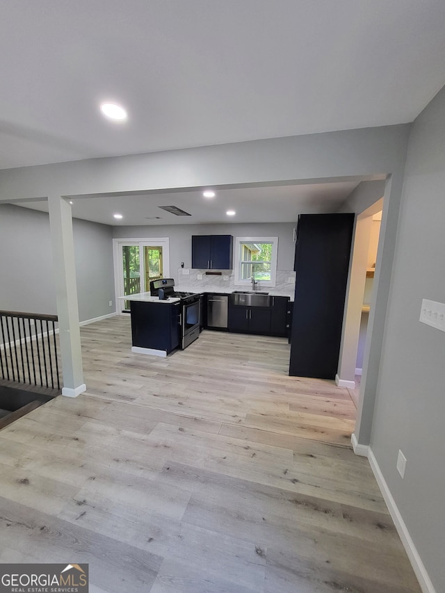 living area featuring baseboards, light wood-style flooring, and recessed lighting