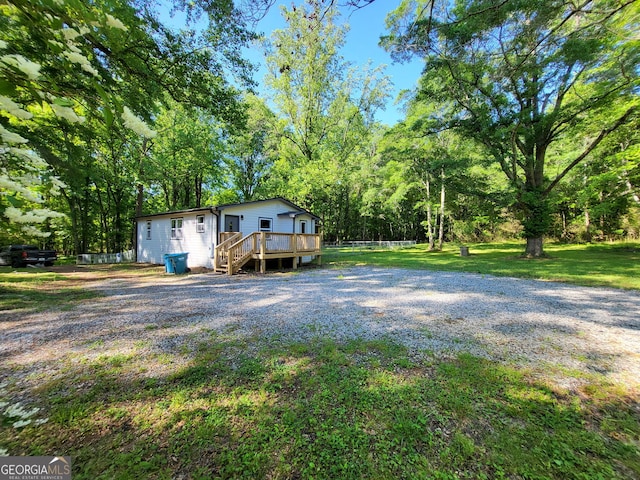 view of front facade featuring a front lawn and a deck