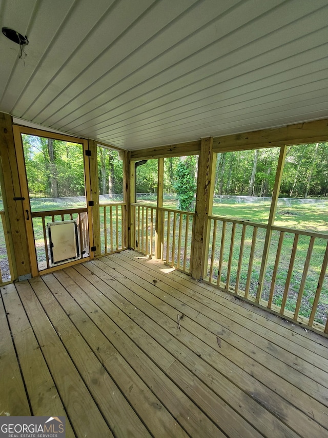 wooden terrace featuring a yard