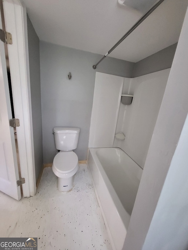 full bathroom with toilet, bathing tub / shower combination, and baseboards
