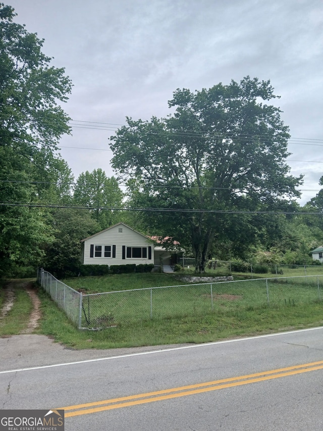 bungalow featuring a fenced front yard and a front yard