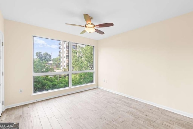 275 13th St NE Unit 409, Atlanta, GA 30309 - spare room featuring wood finished floors and ceiling fan