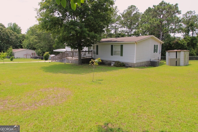 106 Paul Revere Dr, Cusseta, GA 31805 - view of grassy yard featuring a storage unit and a deck
