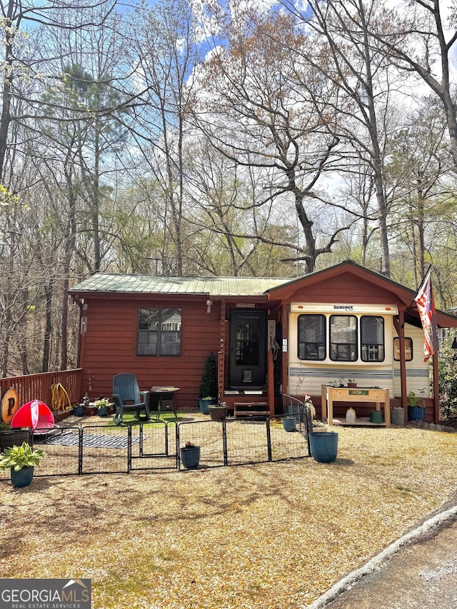 50 Rocky Ln, Cleveland, GA 30528 - view of front facade featuring a gate, metal roof, and a fenced front yard