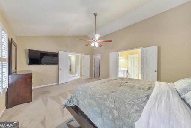bedroom featuring light colored carpet, baseboards, ensuite bathroom, ceiling fan, and high vaulted ceiling