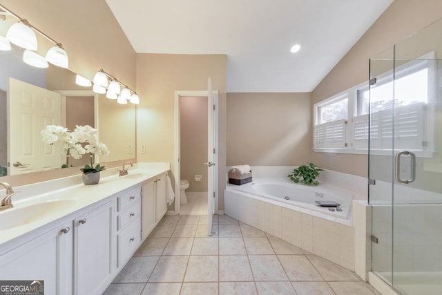 full bathroom featuring toilet, a bath, a shower stall, tile patterned flooring, and double vanity